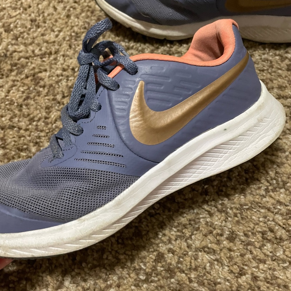 Purple and gold Nike shoes